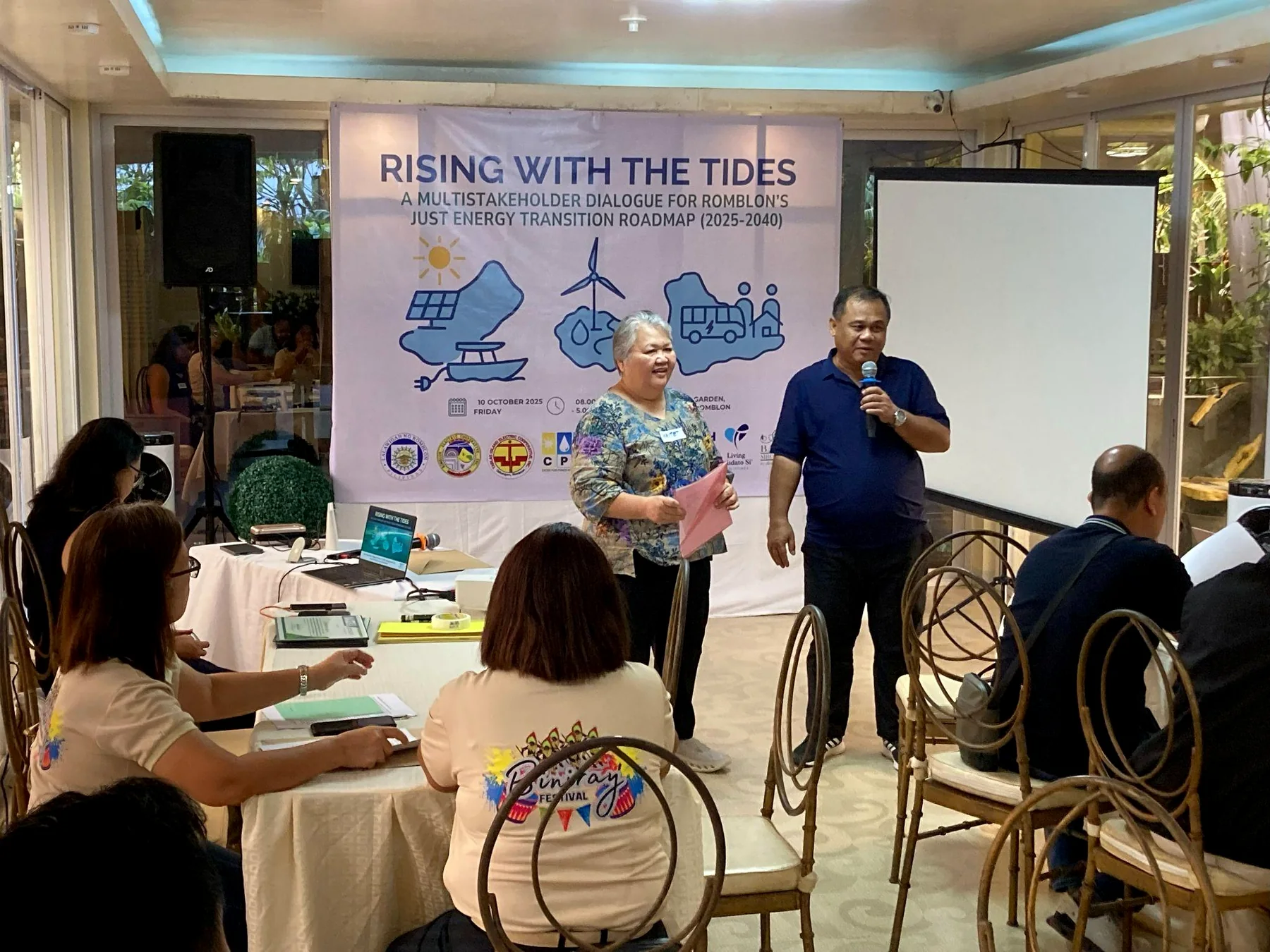 CPII representatives speaking before participants at the Romblon just energy transition dialogue