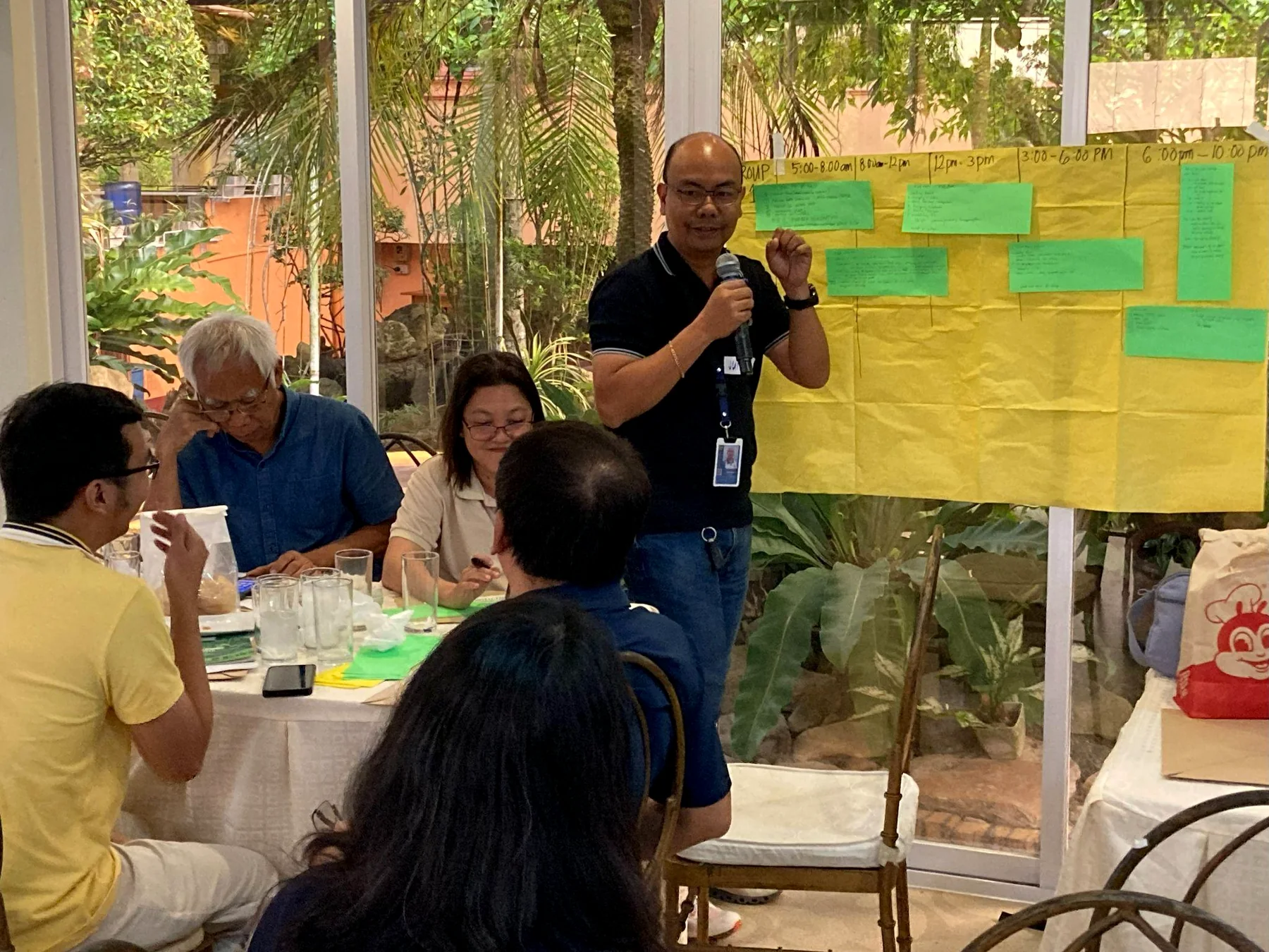 A participant presents a community electricity-use canvas during the Romblon dialogue