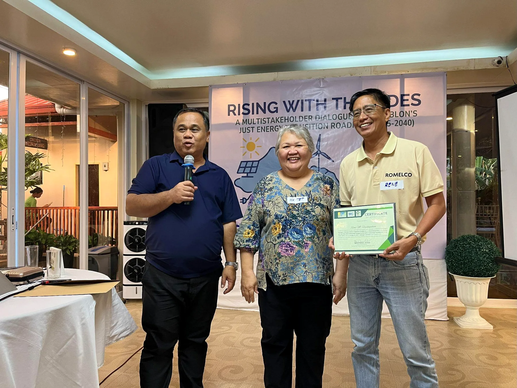 Maitet Diokno and Wilson Fortaleza with the ROMELCO general manager